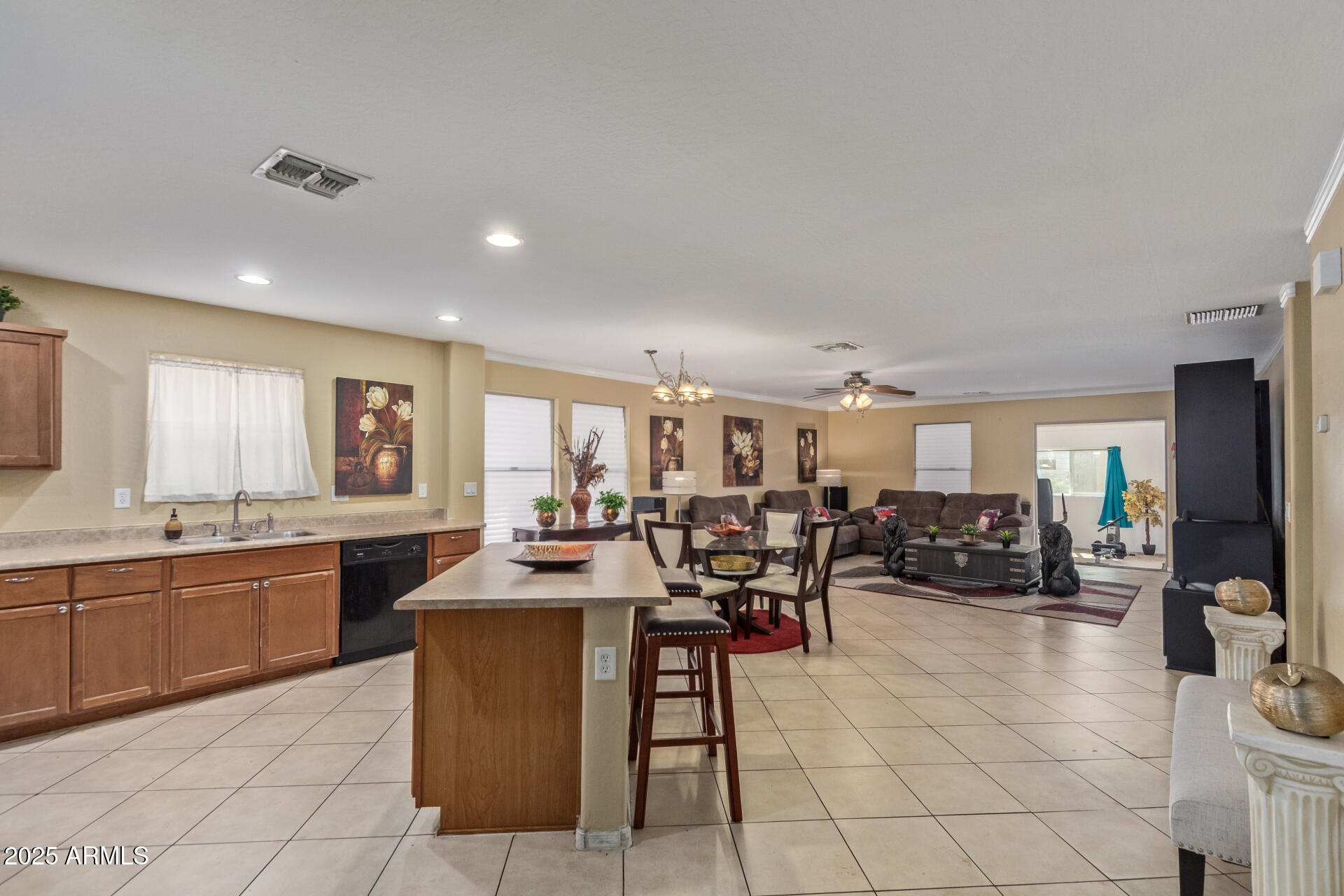 3209 West Apollo Road Phoenix, AZ 85041 - Photo 11 of 40 a large living room with stainless steel appliances granite countertop a sink and cabinets