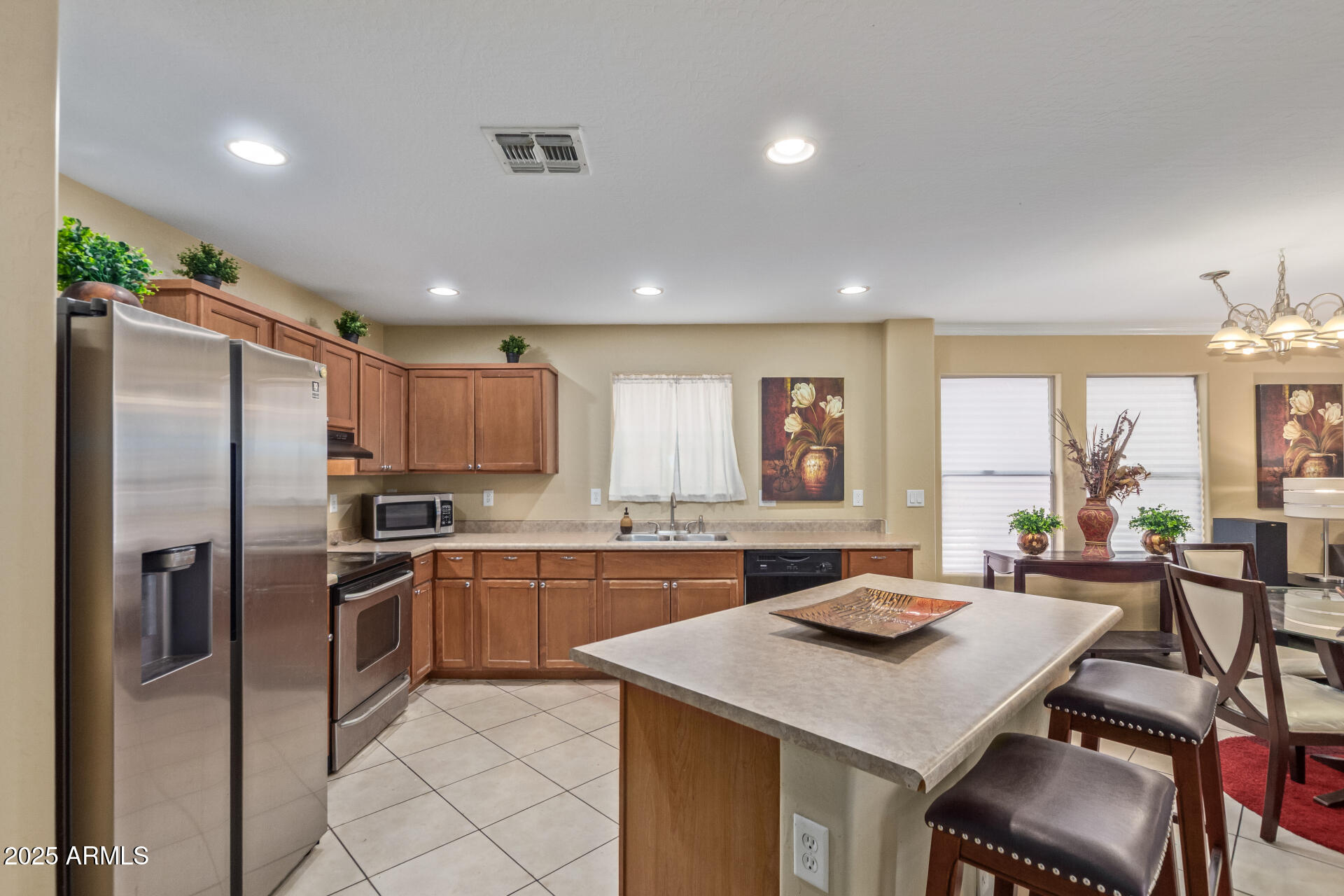 3209 West Apollo Road Phoenix, AZ 85041 - Photo 12 of 40 a kitchen with stainless steel appliances granite countertop a sink stove and refrigerator