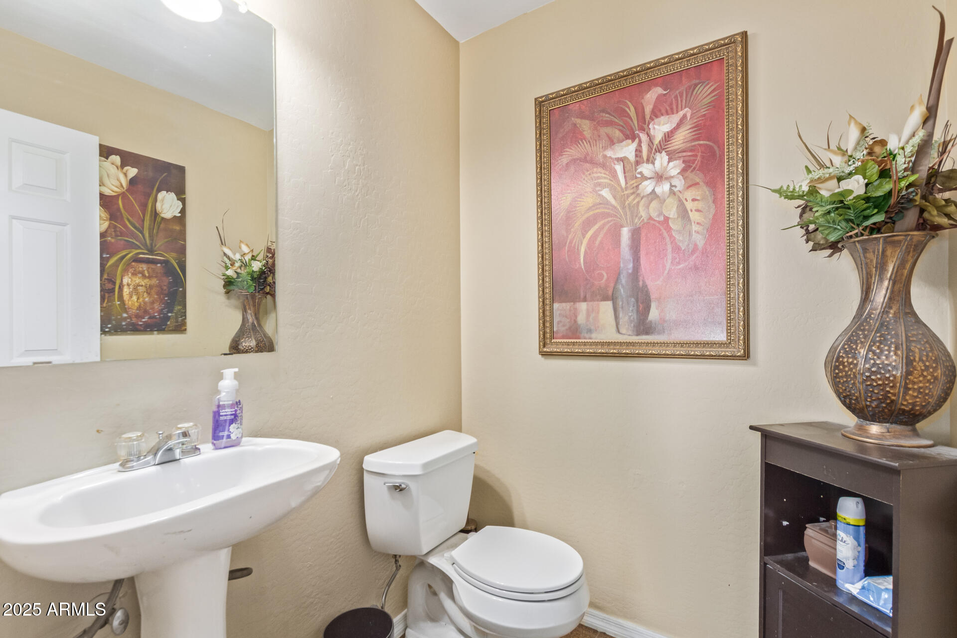 3209 West Apollo Road Phoenix, AZ 85041 - Photo 17 of 40 a bathroom with a toilet sink and mirror