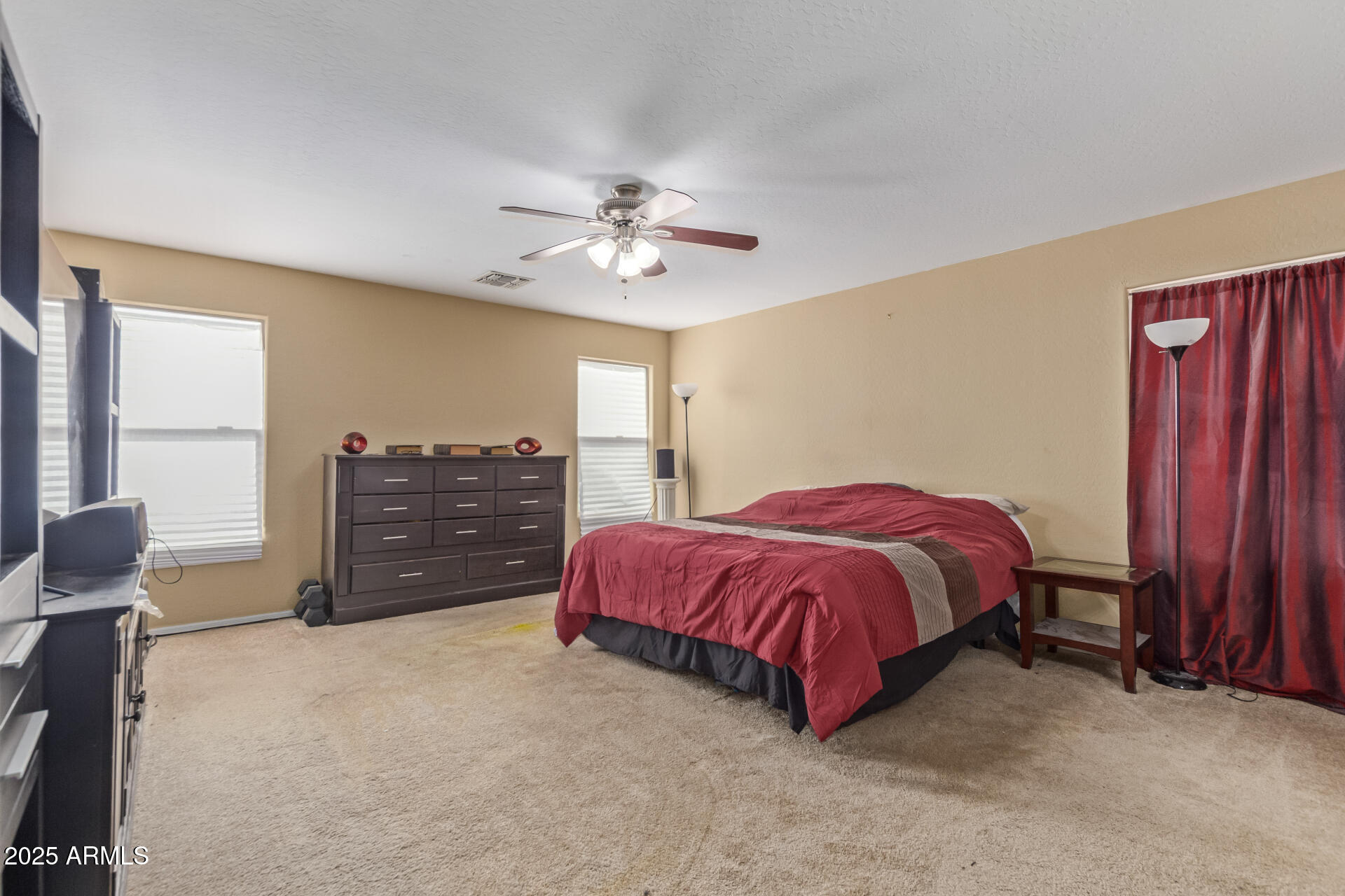 3209 West Apollo Road Phoenix, AZ 85041 - Photo 18 of 40 a spacious bedroom with a bed and a chandelier