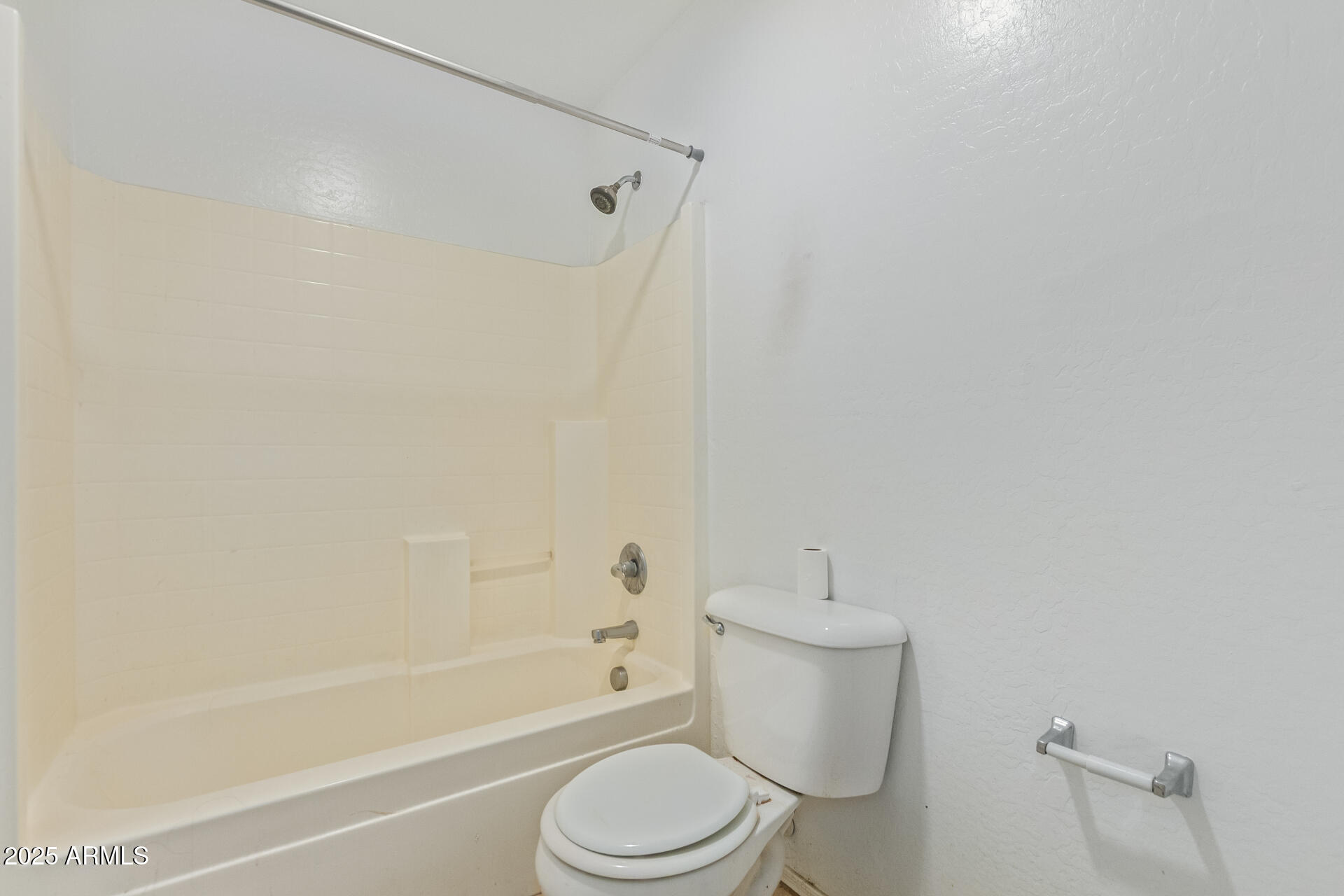 3209 West Apollo Road Phoenix, AZ 85041 - Photo 30 of 40 a bathroom with a toilet and a bathtub