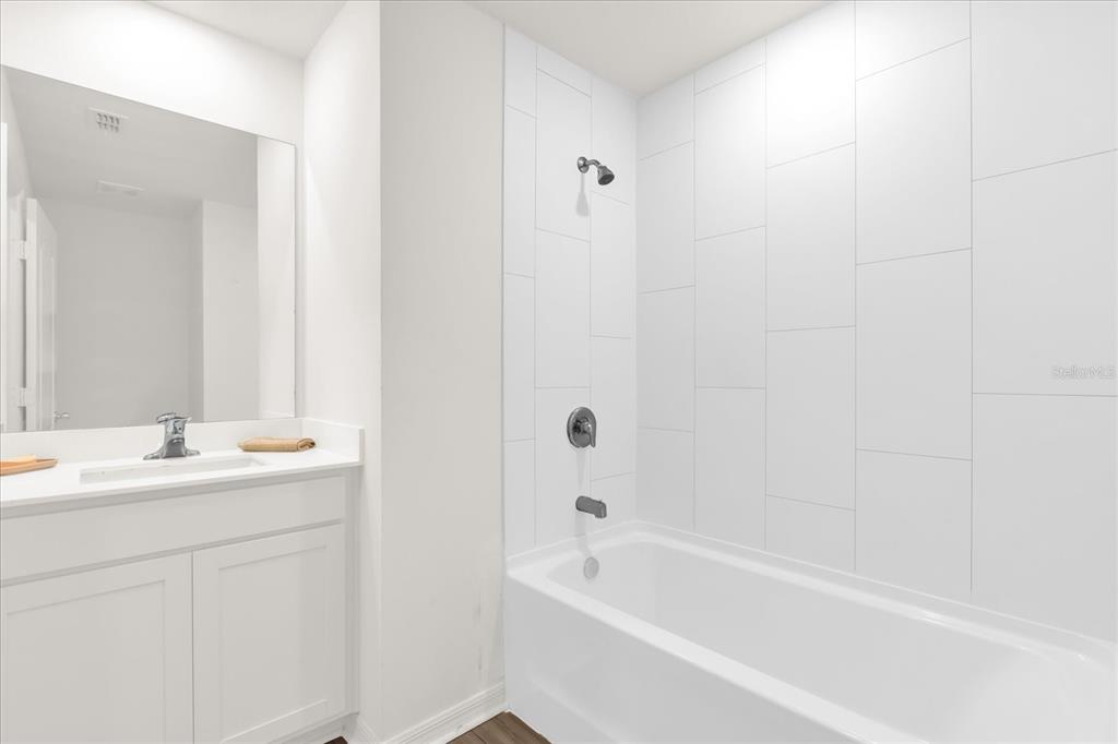 2134 Rio Grande Canyon Loop Poinciana, FL 34759 - Photo 9 of 22 a bathroom with a tub sink vanity and a mirror