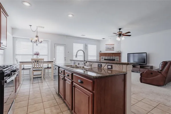 a kitchen with stainless steel appliances a sink stove and cabinets