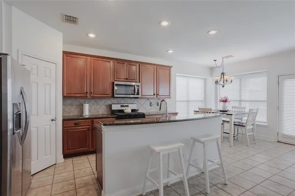a kitchen with appliances a sink and cabinets