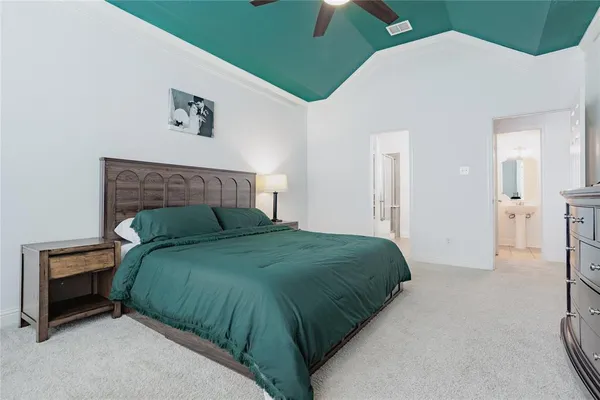 a bedroom with a bed and a painting