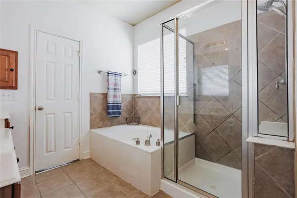 a bathroom with a bathtub and a shower