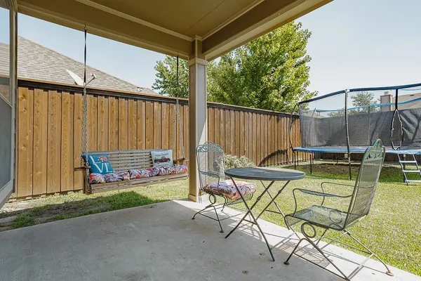 a view of a chairs and table in the patio