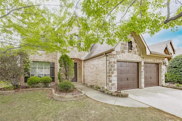 front view of a house with a tree