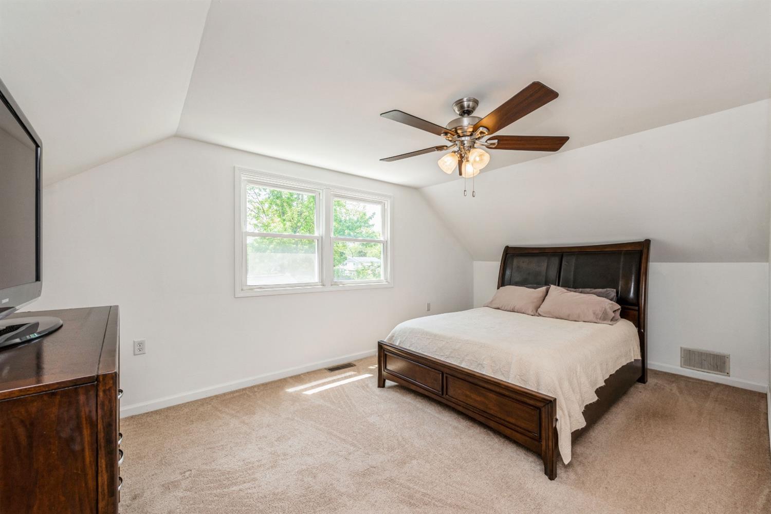 710 Heritage Road Valparaiso, IN 46385 - Photo 13 of 27 a bed sitting in a bedroom next to a window