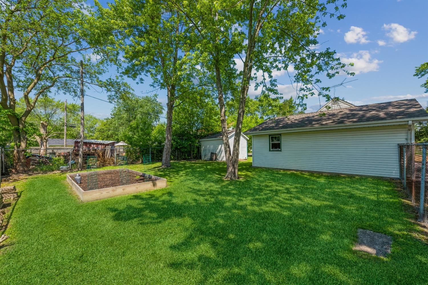 710 Heritage Road Valparaiso, IN 46385 - Photo 21 of 27 a view of a backyard with plants and a large tree