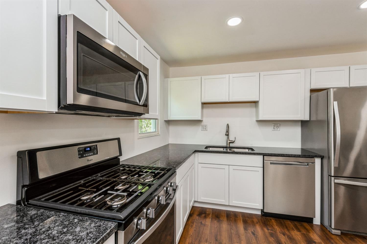 710 Heritage Road Valparaiso, IN 46385 - Photo 7 of 27 a kitchen with stainless steel appliances a stove a microwave sink and cabinets