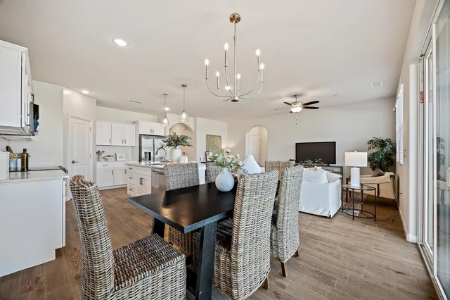 a view of a dining room with furniture and wooden floor