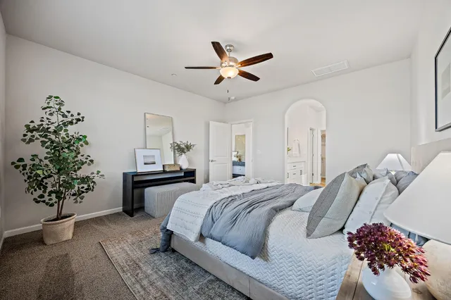 a bedroom with a bed and a potted plant