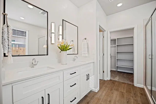 a bathroom with a sink double vanity and a mirror