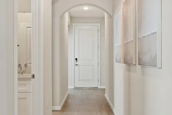 a view of a hallway with wooden floor