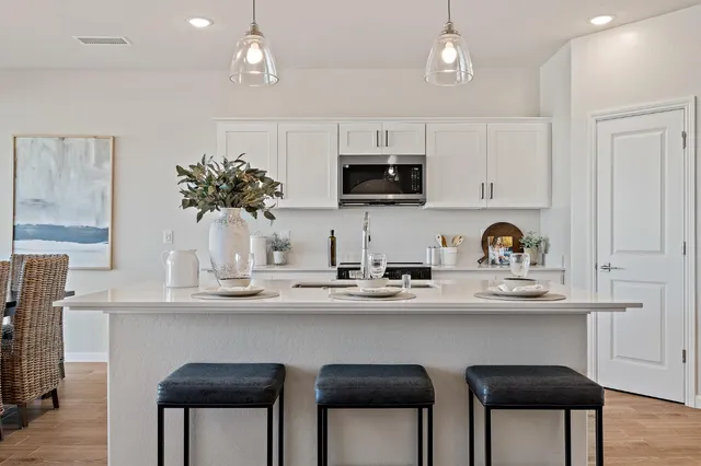 a kitchen with stainless steel appliances a sink and cabinets