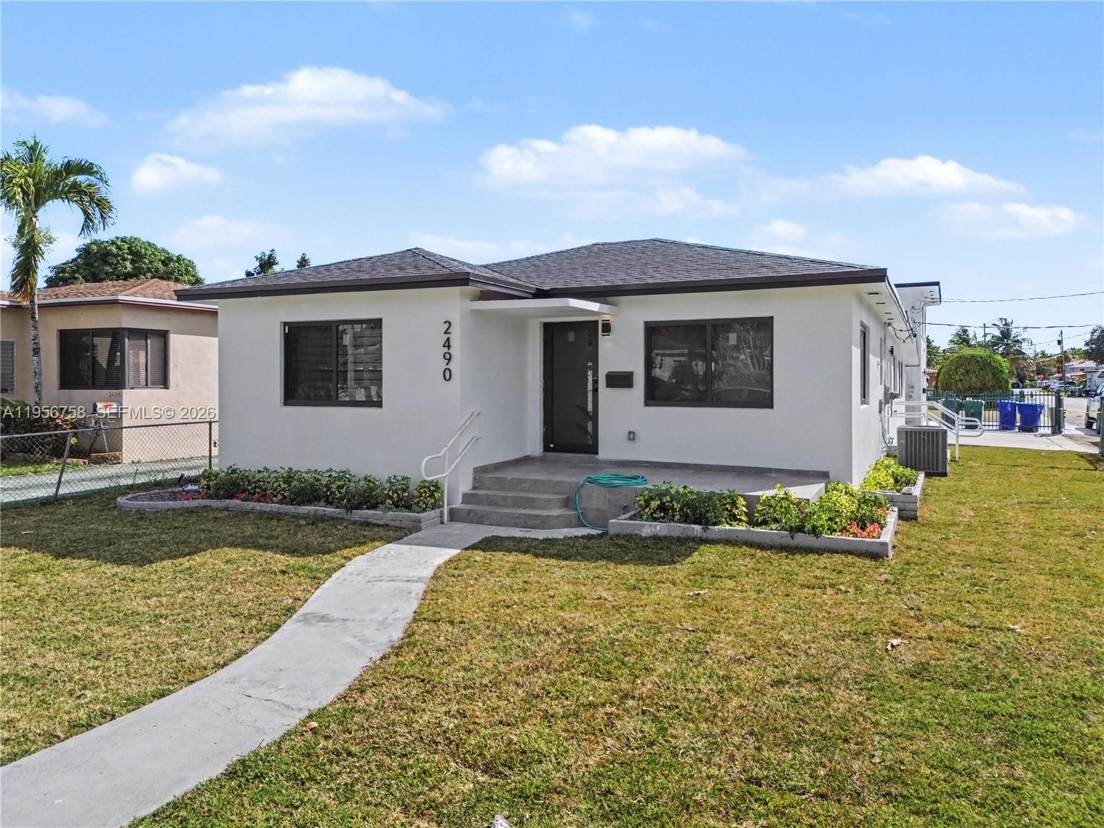 a front view of a house with garden