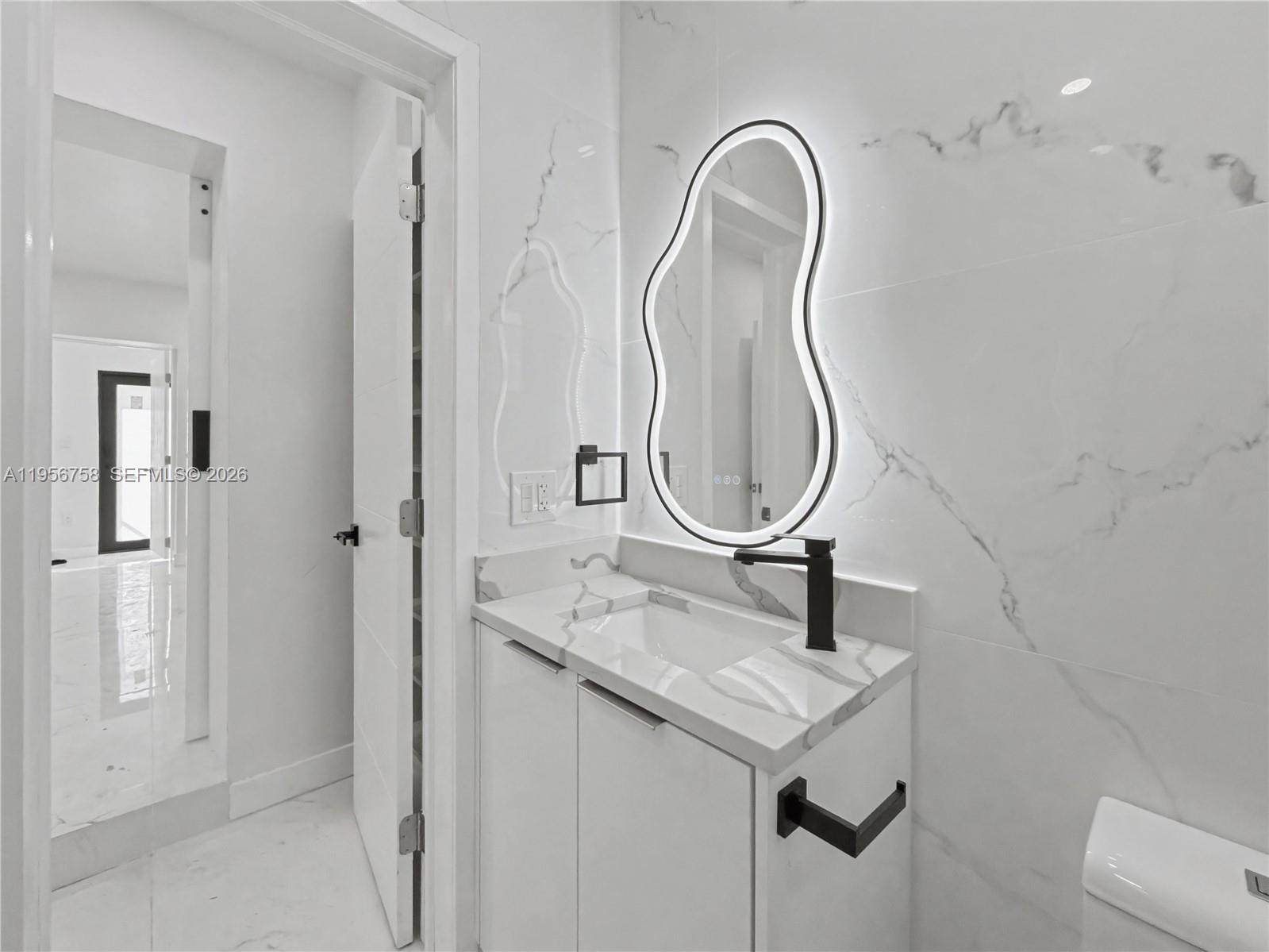 2490 Southwest 17th Street Miami, FL 33145 - Photo 16 of 36 a bathroom with a sink and a mirror