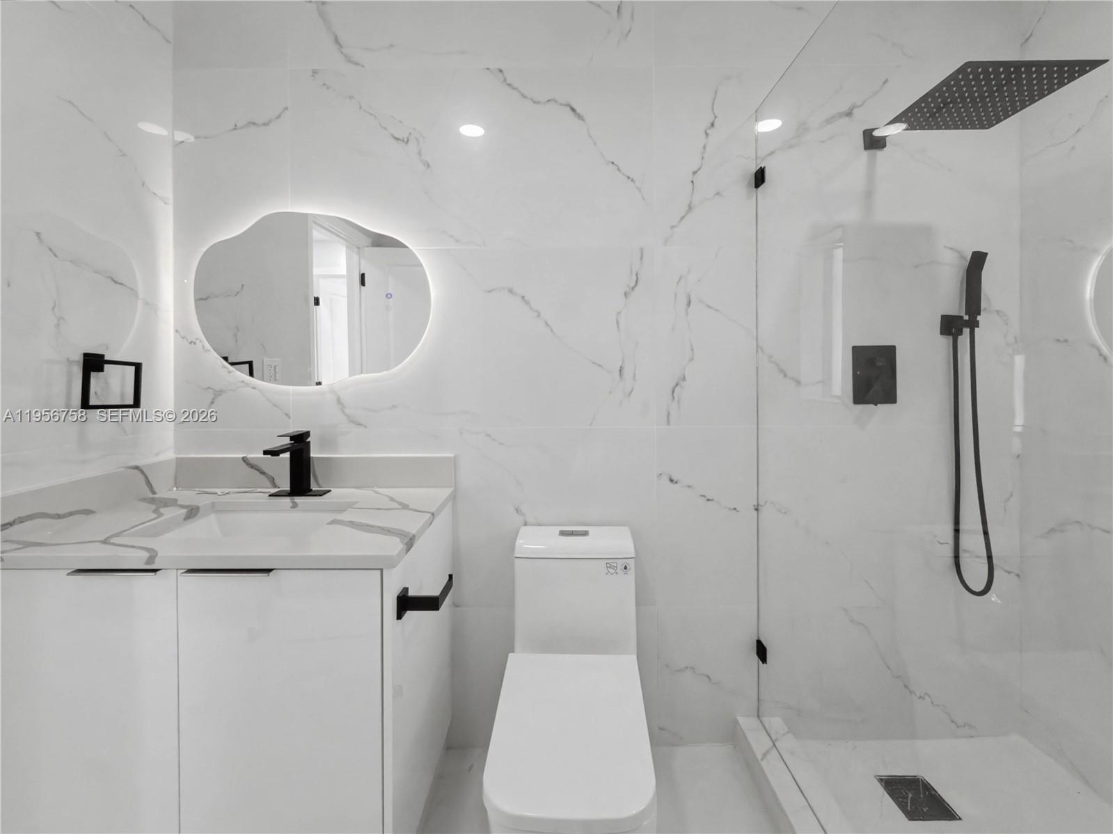 2490 Southwest 17th Street Miami, FL 33145 - Photo 22 of 36 a bathroom with a granite countertop sink mirror and toilet