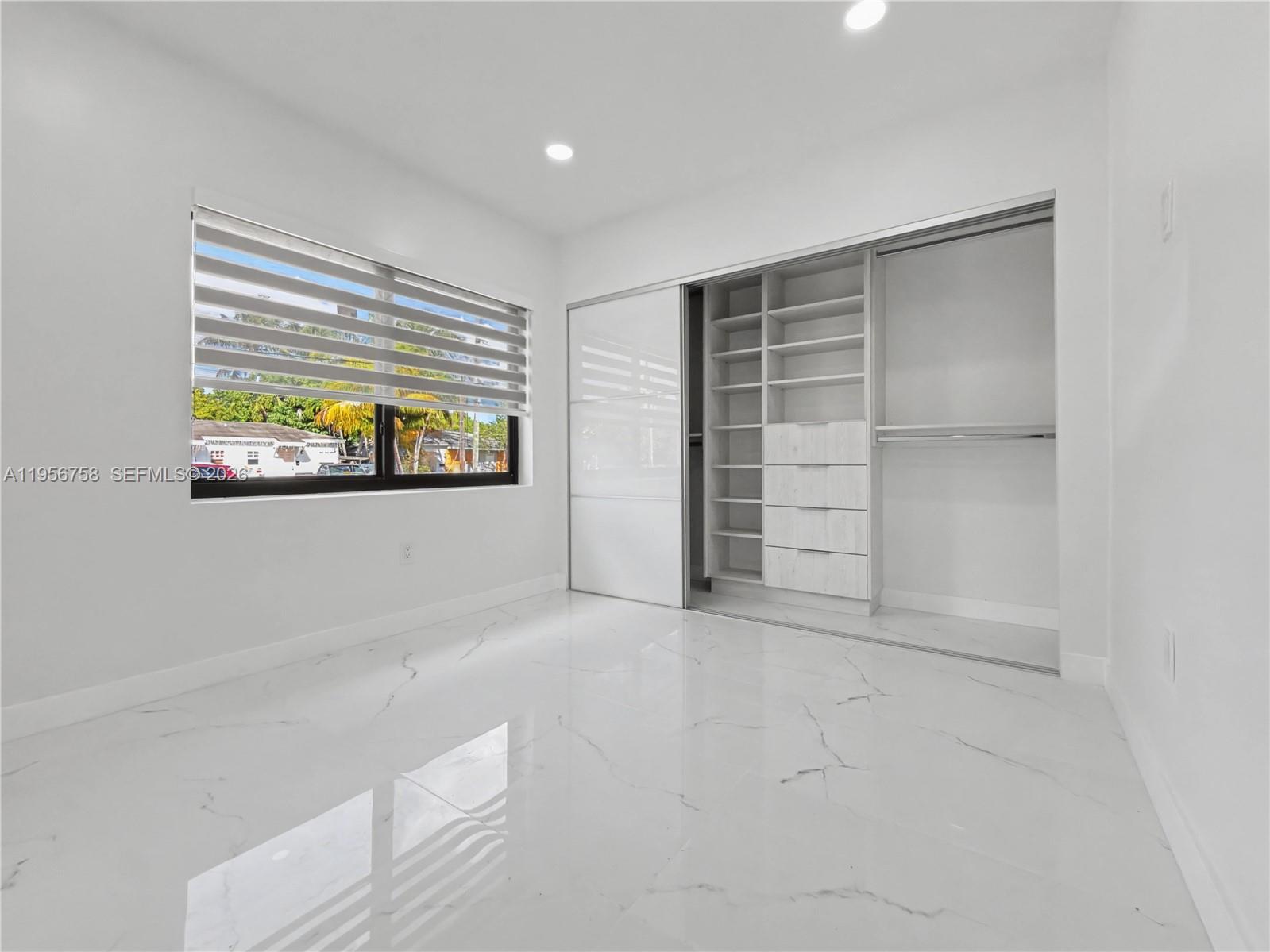 2490 Southwest 17th Street Miami, FL 33145 - Photo 24 of 36 an empty room with a window and a ceiling fan