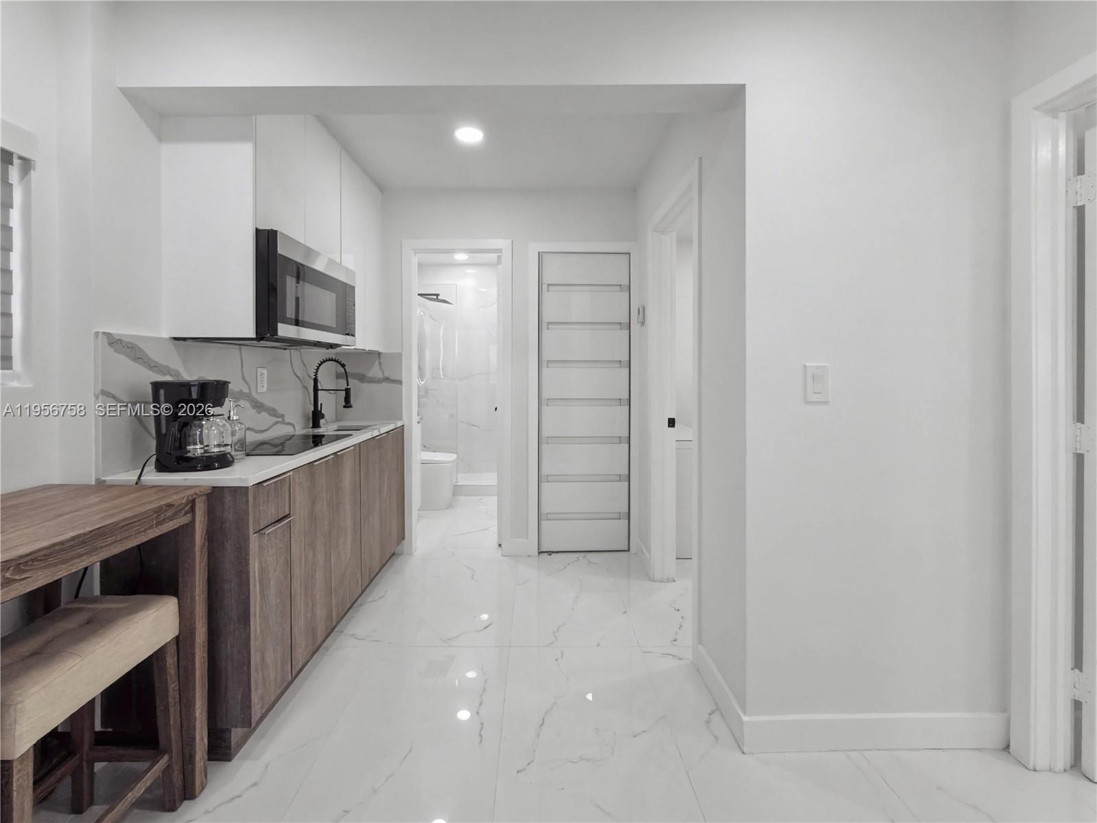 2490 Southwest 17th Street Miami, FL 33145 - Photo 27 of 36 a kitchen with cabinets and a stove