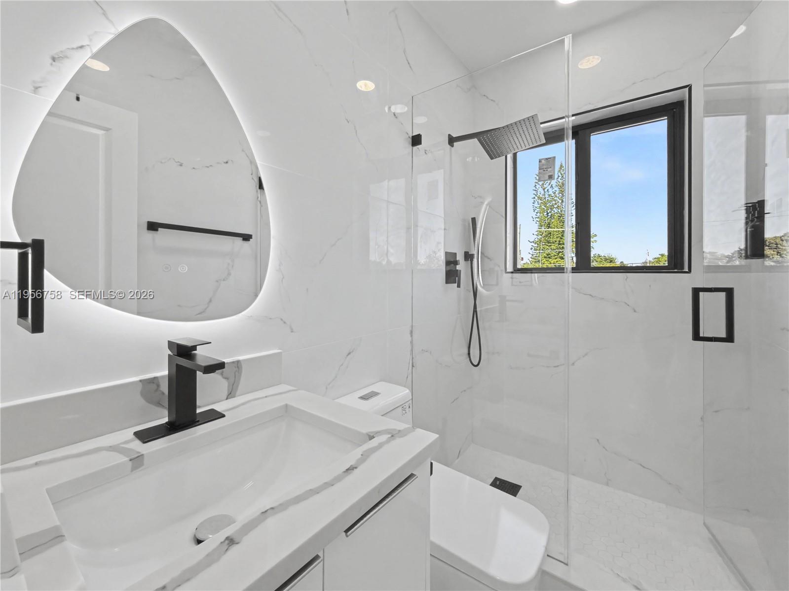 2490 Southwest 17th Street Miami, FL 33145 - Photo 36 of 36 a bathroom with a sink a toilet and mirror