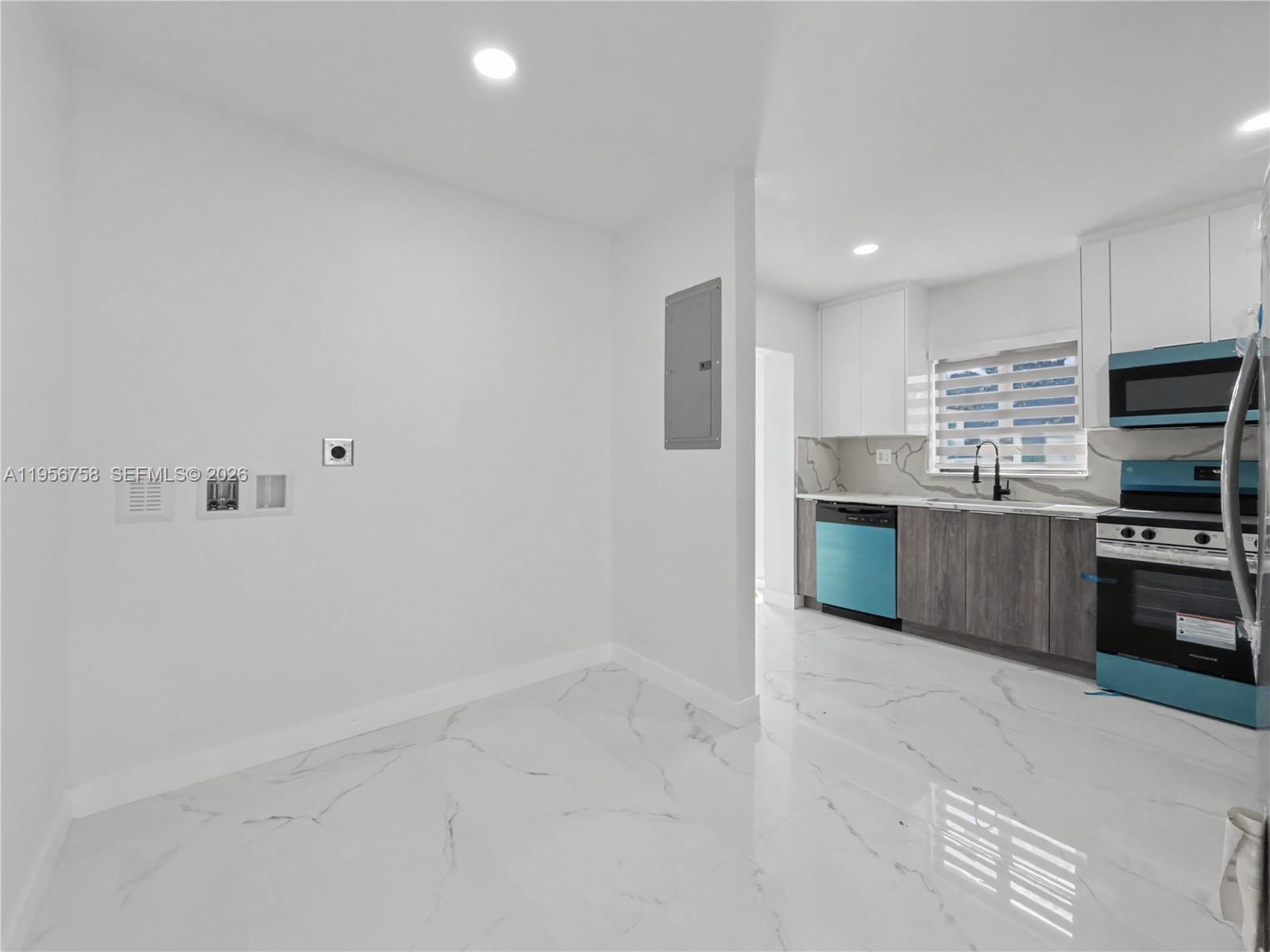 2490 Southwest 17th Street Miami, FL 33145 - Photo 9 of 36 a kitchen with stainless steel appliances a sink stove and refrigerator