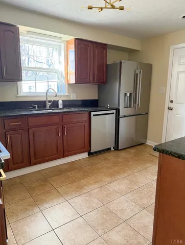 a kitchen with stainless steel appliances granite countertop a refrigerator and sink