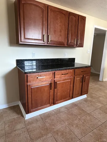 a kitchen with granite countertop cabinets and wooden floor