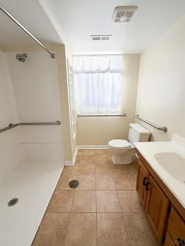 a bathroom with a granite countertop sink a toilet and a bathtub