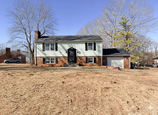 a front view of a house with a yard covered with snow in front of house