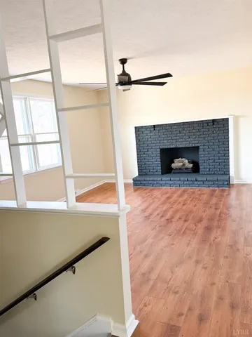 a view of a living room with a fireplace