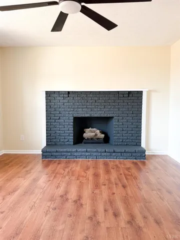 a view of empty room with a fireplace