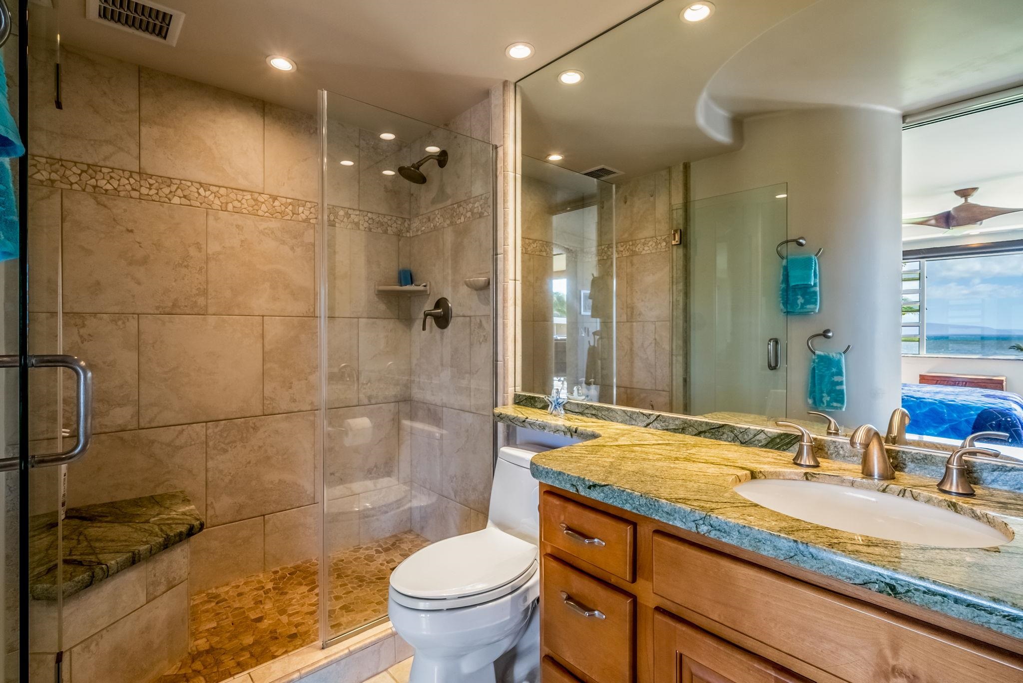 760 South Kihei Road, Unit 522 Kihei, HI 96753 - Photo 18 of 48 a bathroom with a granite countertop sink a toilet a mirror and shower