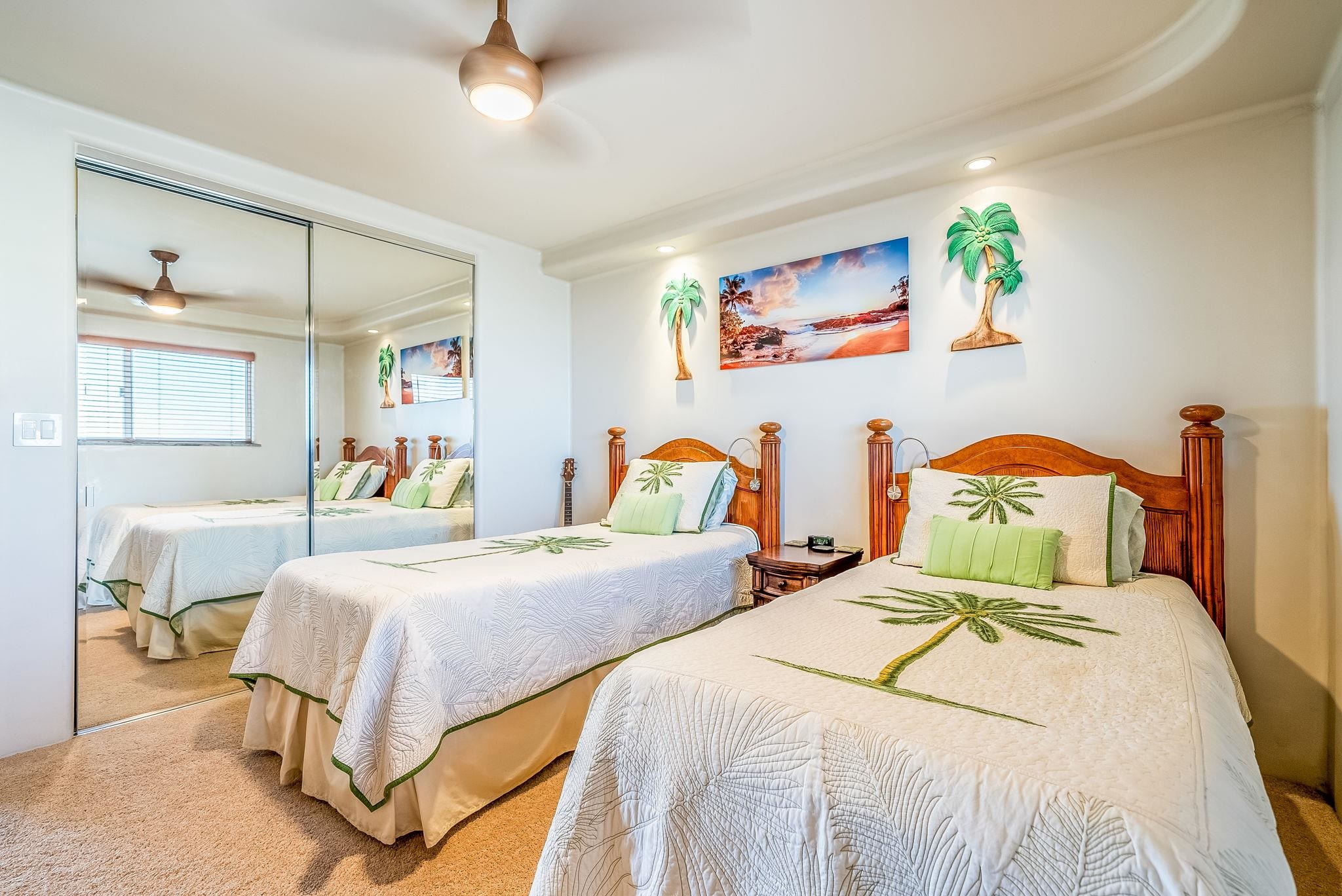 760 South Kihei Road, Unit 522 Kihei, HI 96753 - Photo 23 of 48 a bedroom with two beds and a chandelier