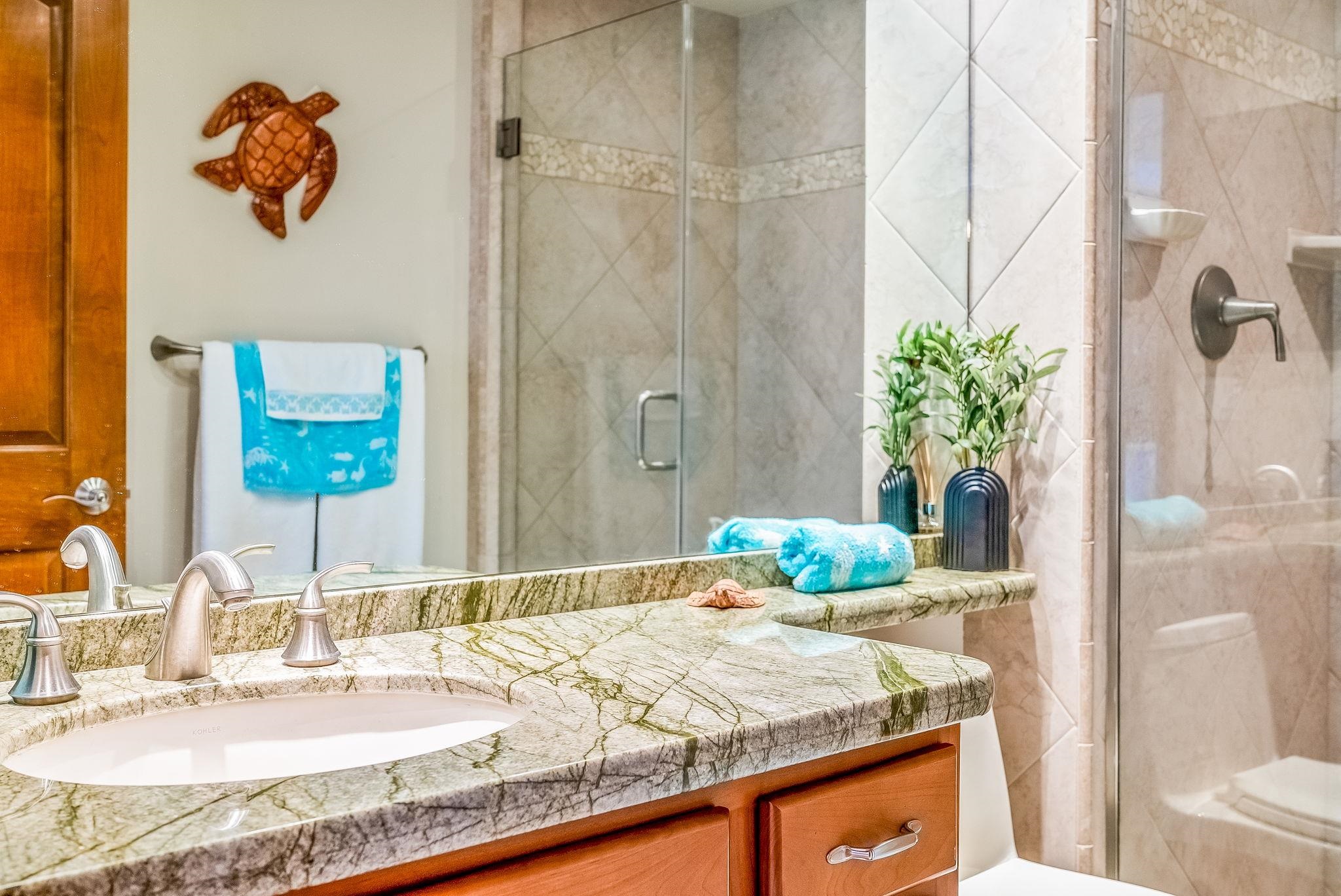 760 South Kihei Road, Unit 522 Kihei, HI 96753 - Photo 24 of 48 a bathroom with a granite countertop sink a mirror and a shower curtain