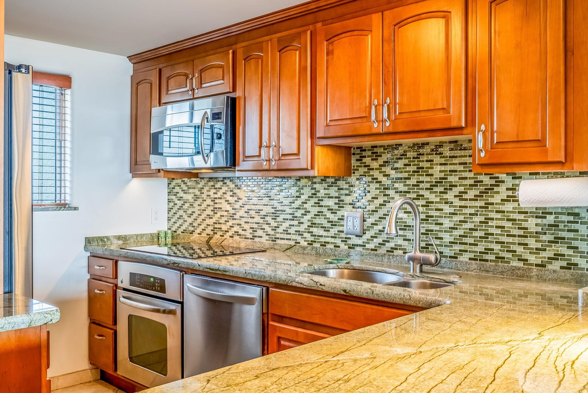 760 South Kihei Road, Unit 522 Kihei, HI 96753 - Photo 27 of 48 a kitchen with stainless steel appliances granite countertop a sink a stove and a microwave