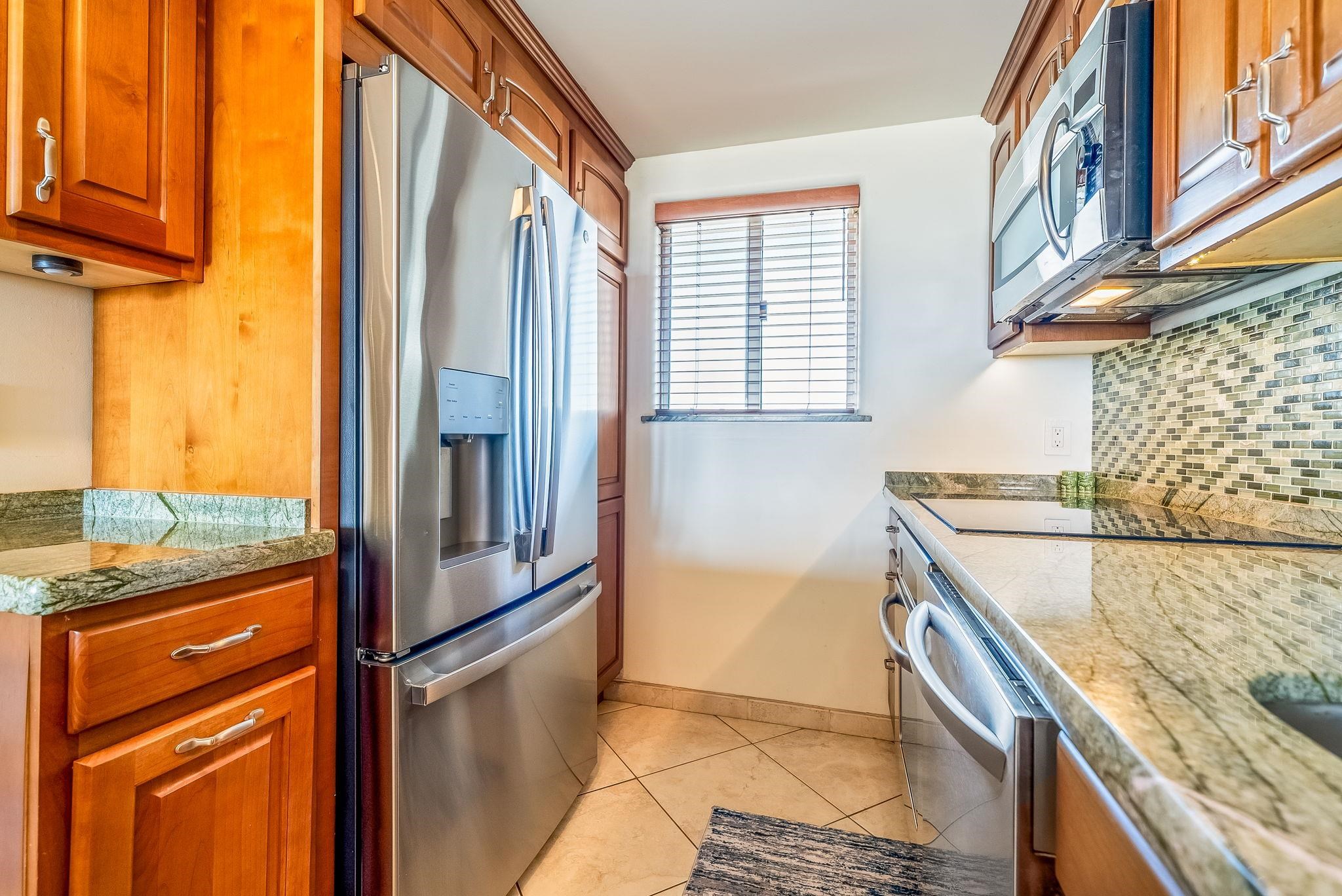 760 South Kihei Road, Unit 522 Kihei, HI 96753 - Photo 28 of 48 a kitchen with stainless steel appliances granite countertop a refrigerator and a stove