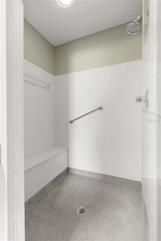 a bed room with a bed and a chair