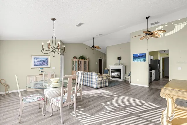 a living room with furniture a fireplace and a table