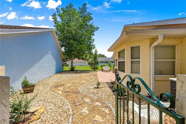 a view of a backyard with sitting area