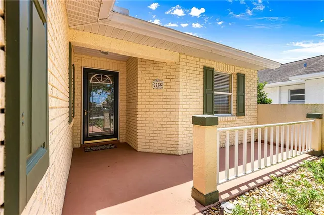 a view of a porch with a table and chair