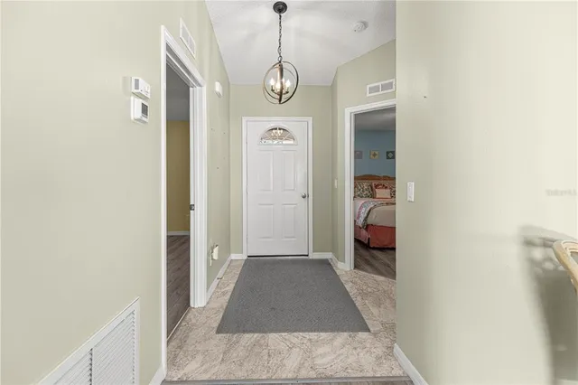 a view of a room with wooden floor and a ceiling fan