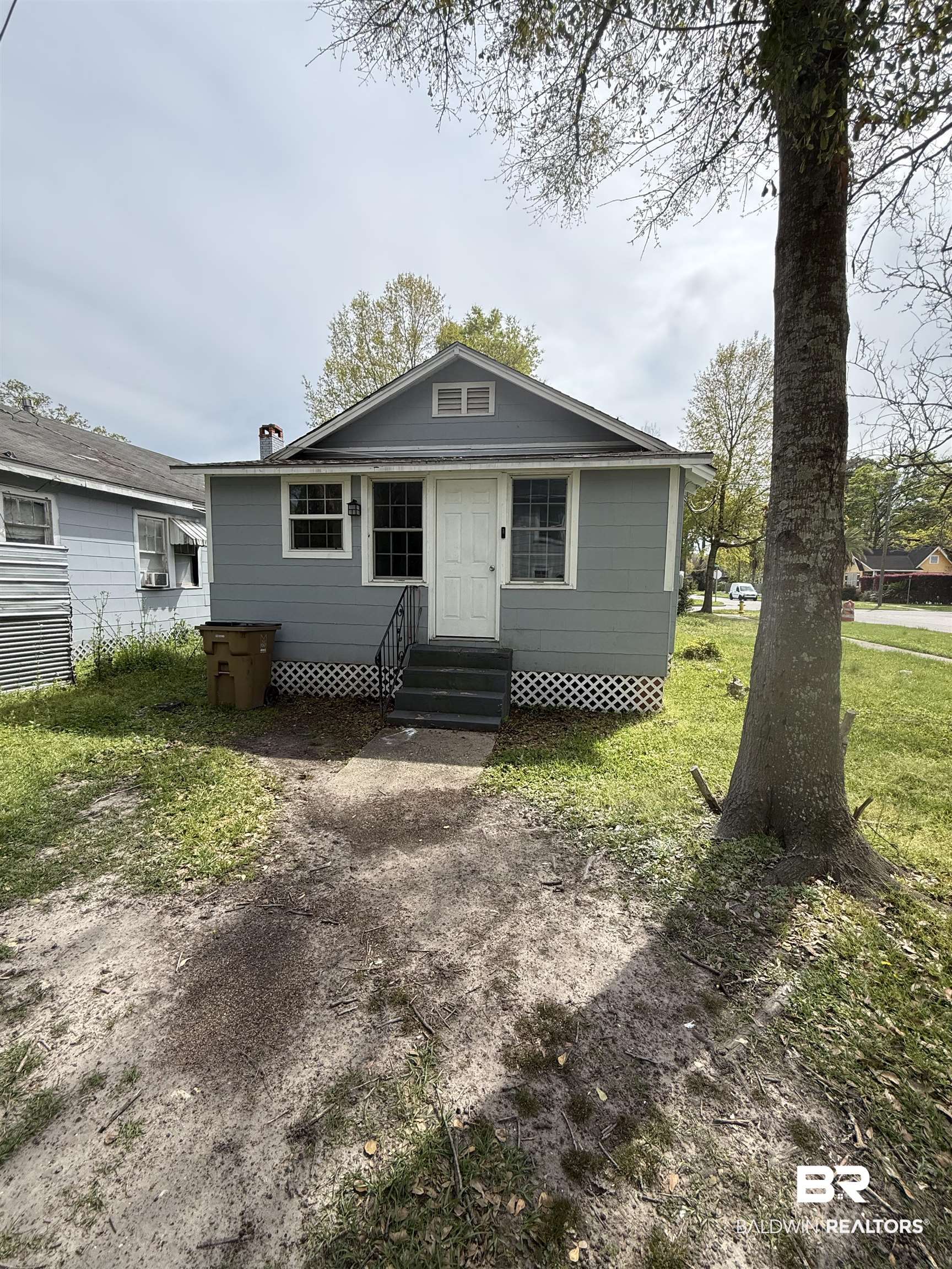 1848 Canal Street Mobile, AL 36606 - Photo 10 of 11 Bungalow-style house featuring entry steps, a front yard, and a chimney