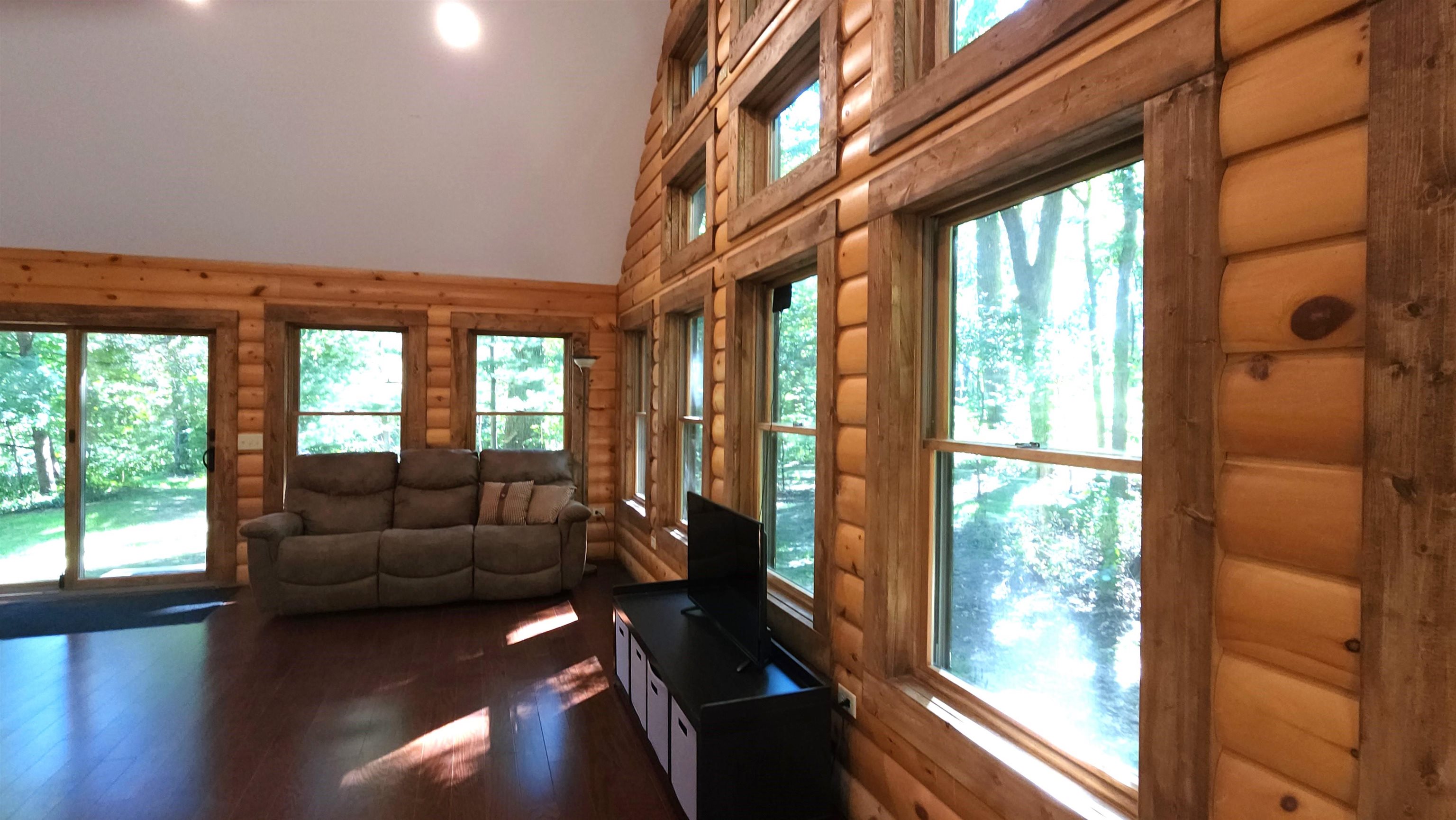 6262 North Eggert Road Rock City, IL 61070 - Photo 23 of 75 a living room with furniture and floor to ceiling windows