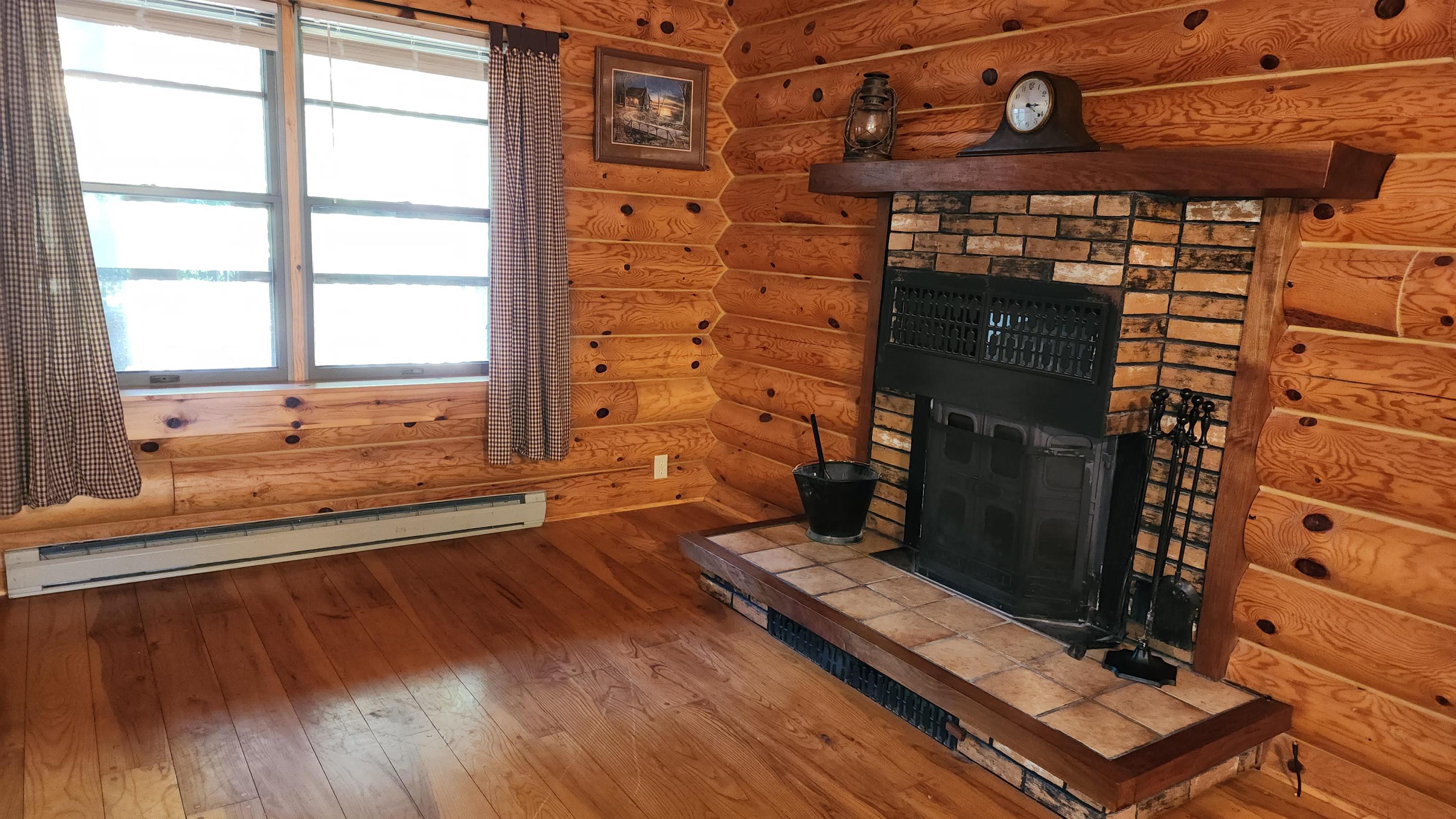 6262 North Eggert Road Rock City, IL 61070 - Photo 30 of 75 a view of a fireplace with wooden floor