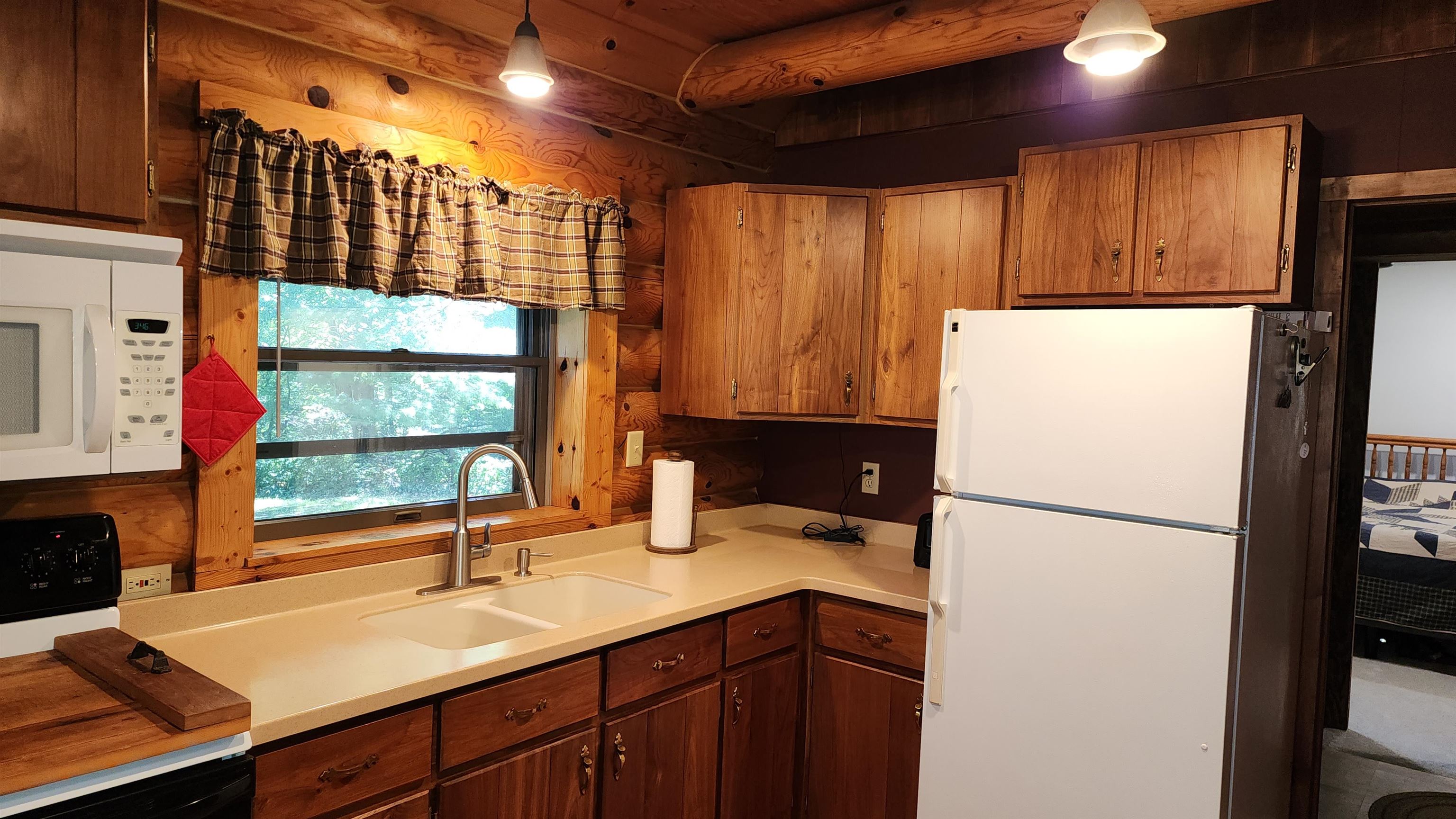 6262 North Eggert Road Rock City, IL 61070 - Photo 35 of 75 a kitchen with a refrigerator and a sink