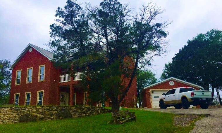 1980 Compass Way Bluff Dale, TX 76433 - Photo 2 of 16 a front view of a house with a yard and trees