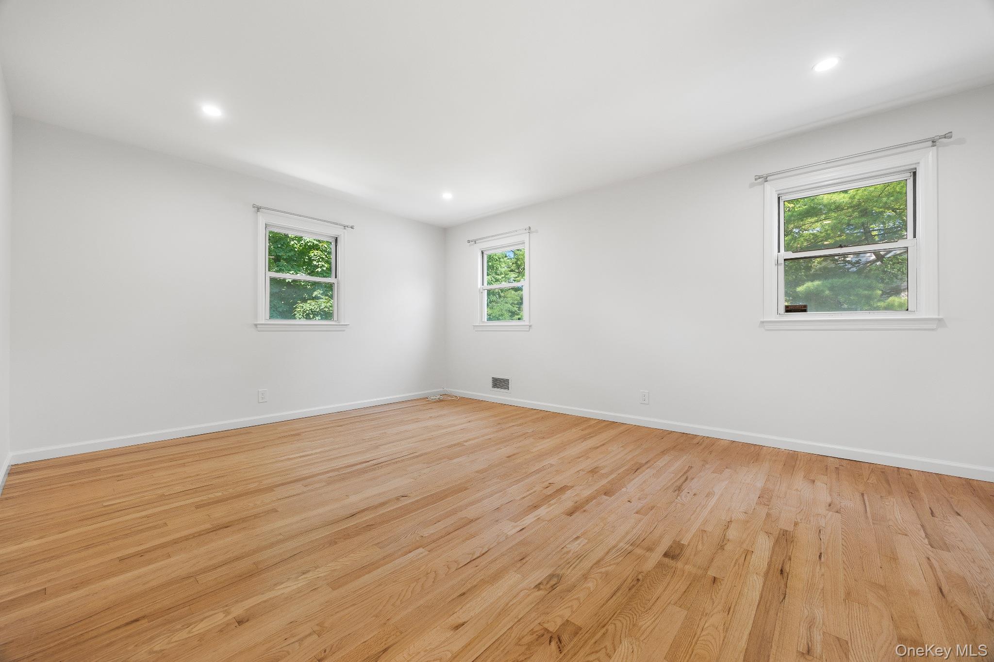 372 Heathcote Road Scarsdale, NY 10583 - Photo 14 of 20 Empty room with light wood-style floors and recessed lighting