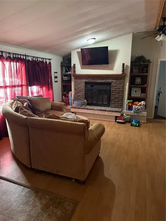 a living room with furniture a flat screen tv and a fireplace
